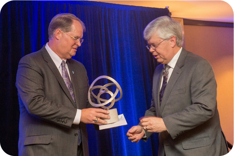 Ron Carpenter (left), Indiana State University Foundation President, presents the 2014 March On! Corporate and Foundation Award to Tom Rocklin, manager of Midwest communications for Siemens PLC, in recognition of Simen's in kind gift of $9.7 million in so